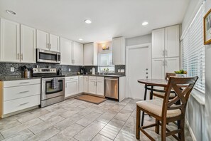 Enjoy meals in the kitchen with a dining area and stainless steel oven.