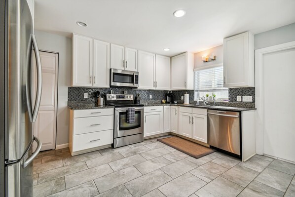 Enjoy cooking in this well-equipped kitchen with oven, microwave, and dishwasher, plus ample counter space for food preparation.