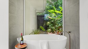 Bathtub, hair dryer, towels, soap