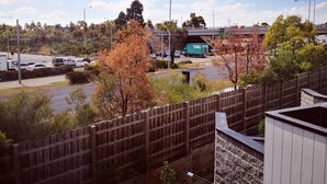 A view of a highway with a toll booth and a bridge in the background. - Delicate Bundoora townhouse 10 (Bundoora)