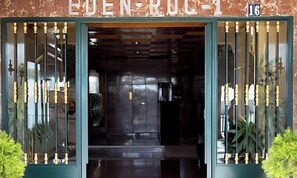 A building entrance with a sign reading 'EDEN RUC 16' and a metal gate.