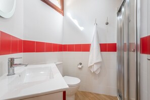 A bathroom with a white sink, toilet, and shower. - Charming Holiday Home "Casa Pequeña Crestatx" with Wi-Fi, Garden, Terraces & Pool (CRESTATX)