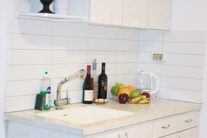 Fridge, coffee/tea maker, electric kettle, cookware/dishes/utensils