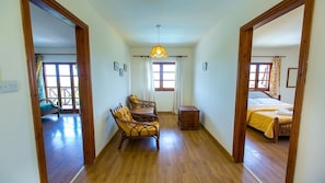 Enter a functional and comfortable space with a seating area and bedroom, perfect for relaxing and socializing.