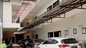 A multi-level parking garage with several cars parked. - D’Paragon Tambakboyo (Depok)