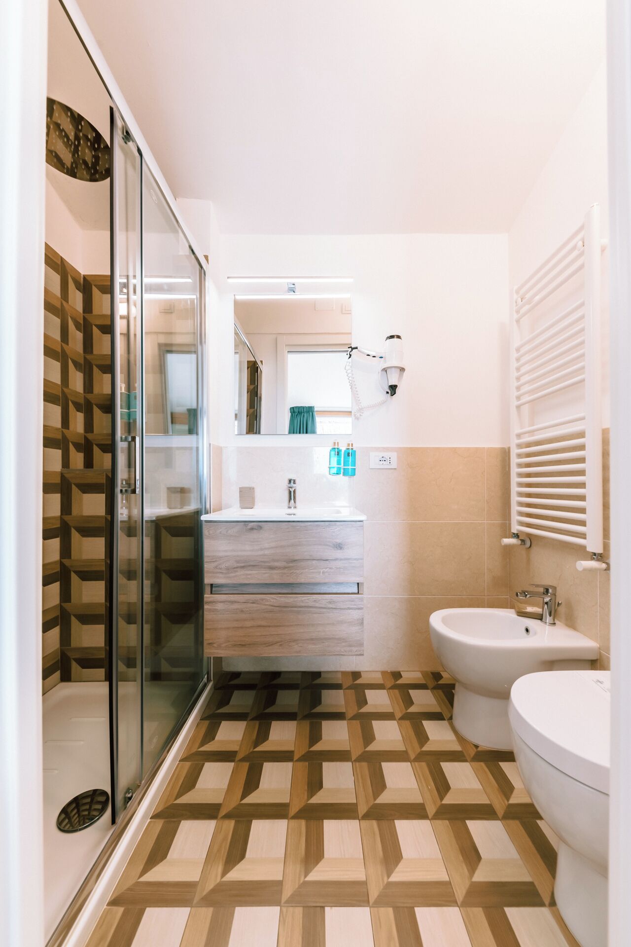 A modern bathroom with a shower, toilet, and sink.