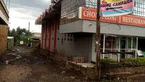 A two-story building with a sign for 'CHOZ RUSKE' and 'RB RESTAURANT'. - Caldera Suites (Nakuru)