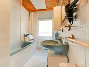 A bathroom with a large sink, a mirror, and a shower. - Apartment in Eberndorf Near Petzen Ski Area (Eberndorf)
