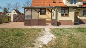 A two-story house with a red-tiled roof, a brick exterior, and a small front yard. - Countryside Stay in Meisdorf (Falkenstein)