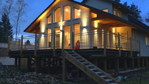 A two-story house with a balcony, a staircase, and a deck. - Tranquil Holiday Home in Winsen near River (Winsen an der Aller)