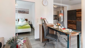 Un apartamento moderno con comedor, cocina y dormitorio.