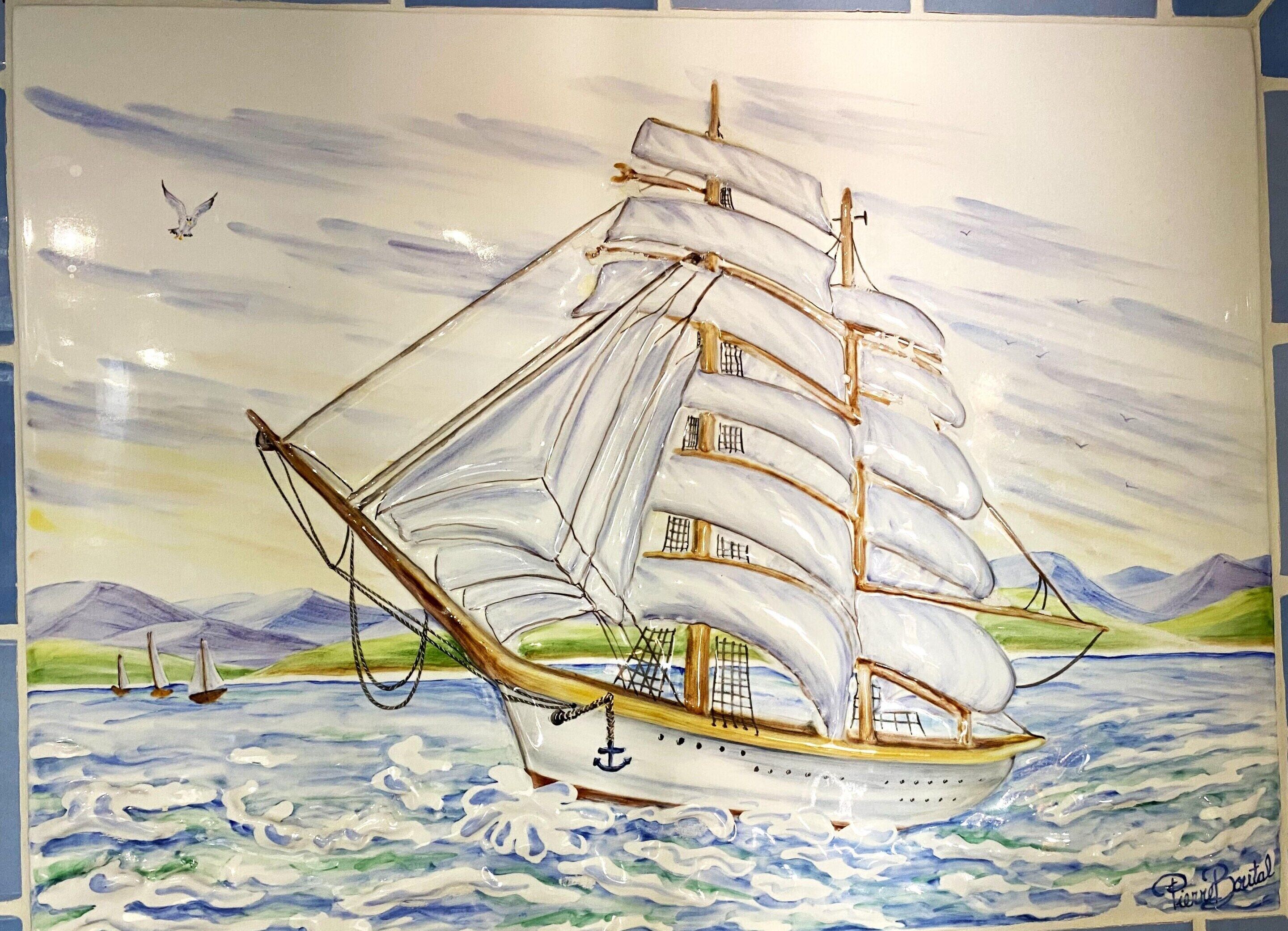 A sailing ship with multiple sails, a cabin, and an anchor.