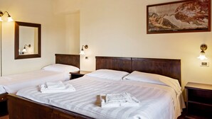 A hotel room with two beds, wooden headboards, and a painting on the wall. - Holiday Home in Magione Near Lake Trasimeno (Magione)