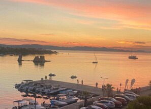 A marina with boats docked, a pier, and a sunset over the water. - Homely Apartment in Sukošan near Sea (Sukosan)