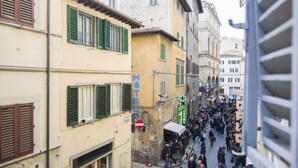 A crowded street with a hotel marked by a blue sign. - Florence City Center Flat Via Dei Neri (Florence)