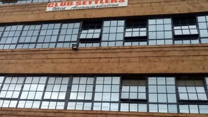 A multi-story building with Club Setters accommodation on the top floor, and a medical centre with pharmacy and dental services on the ground floor. - Club Settlers (Nakuru)