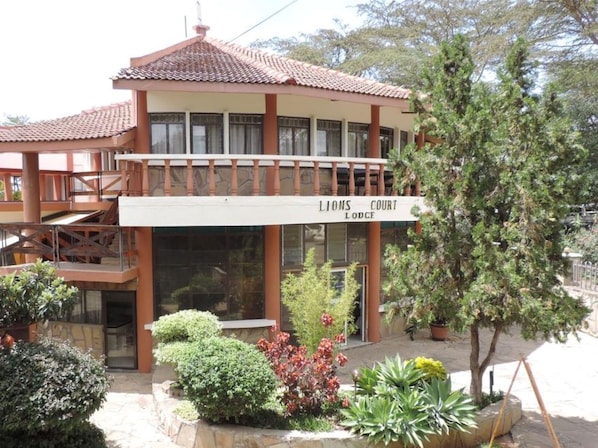 A building with a sign reading "Lions Court Lodge". - Lions Court Lodge (Nanyuki)