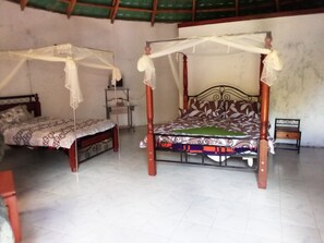 Two single beds with canopy beds in a room with tiled flooring and a simple, functional design. - Mseven Gardens M7 (Nyahururu)