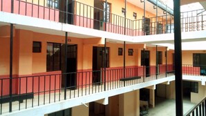 A multi-story building with balconies, windows, and doors. - Rene Bistro Hotel (Nanyuki)