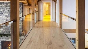 Een houten interieur met een hoge plafond en een centrale lamp.