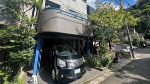 A two-story residential building with a garage. - Sadie's Home (Kawasaki)