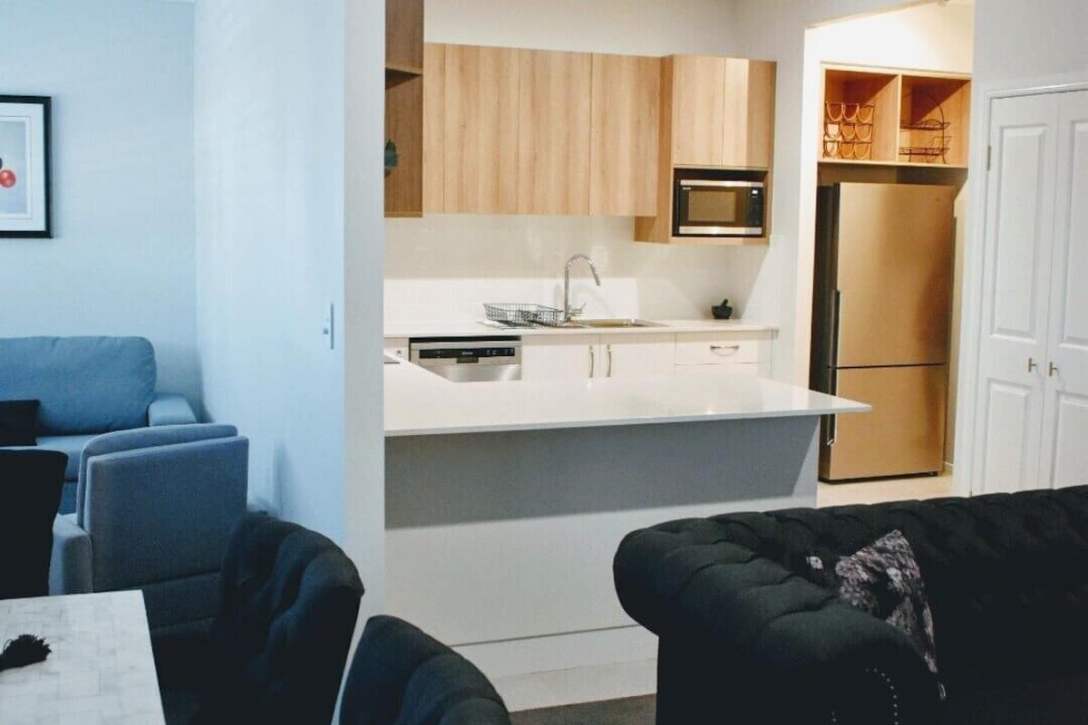 A compact living space with a kitchenette, a dining area, and a seating area.