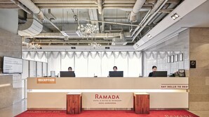 A reception desk with a sign reading "Ramada Hotel & Suites by Wyndham Seoul Namdaemun." - Ramada Hotels & Suites Seoul Namdaemun (Seoul)