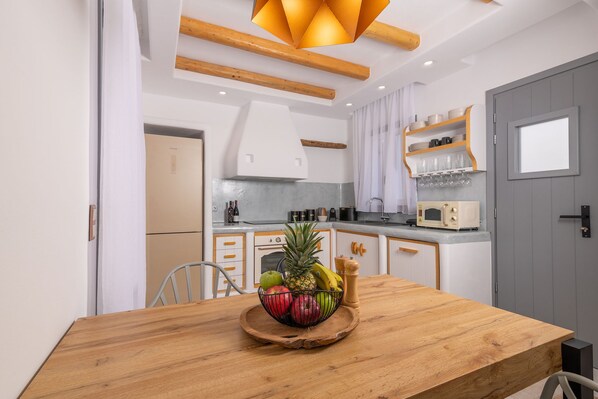 Enjoy cooking in this well-equipped kitchen with an oven, stainless steel countertop, and ample dining space.