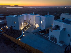 Situated in a hilly area, this building offers a view of distant mountains and a body of water.