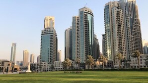 A cityscape with high-rise buildings, including a prominent tower with "EMAAR" signage.