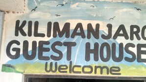 A sign for the Kilimanjaro Guest House with the word "Welcome" below it. - Kilimanjaro Guest House (Nakuru)