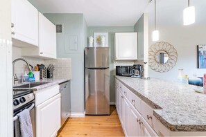 Enjoy cooking in this well-equipped kitchen with an oven, microwave, and coffee maker.