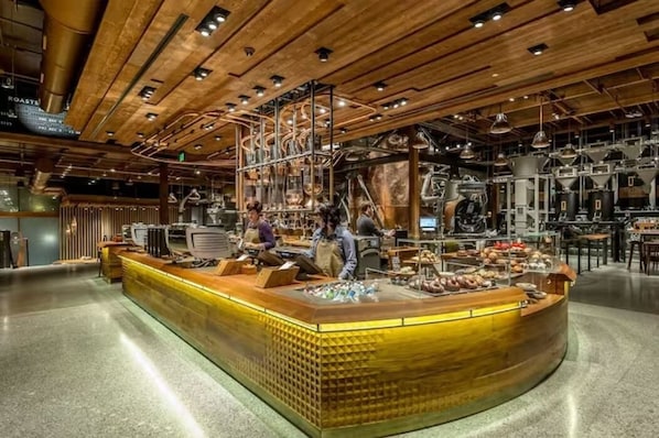 Guests can shop and interact with staff at this central counter area, surrounded by exposed beams and industrial lighting.