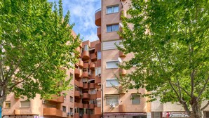 A multi-story building with balconies, a cafe, and a laundry service on the ground floor. - Lovely apartment for 4 people with WIFI, A/C, TV and pets allowed (Calpe)