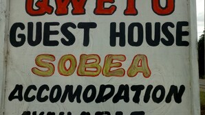 A sign for QWETU GUEST HOUSE with Sobia accommodation available, indicated by an arrow. - Qwetu Guest House (Nakuru)