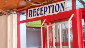 A reception area with a red door and a sign that reads "RECEPTION". - Qwetu Guest House (Nakuru)