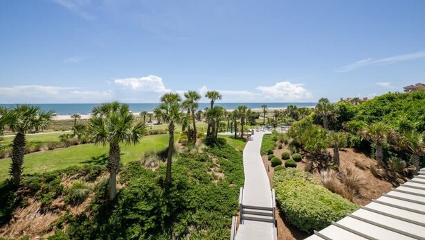 A pathway leading to a beach with palm trees and a clear sky. - Shipwatch #1365 - Heated Pool! (Fernandina Beach)