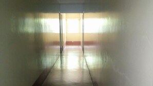 A long, narrow hallway with a smooth floor and light-colored walls. - Sagana Country Hotel (Nyeri)