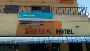 A building with a sign for 'Serena Hotel' and a 'Safaricom' sign above it. - Serena Hotel (Nakuru)