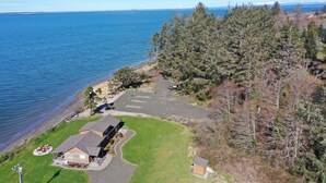 A residential property with a house, driveway, and parking area. - Exclusive Bayside RV Site #4 (Aberdeen)