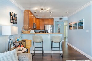 Enjoy a bright and welcoming kitchen with a central island, bar stools, and a cozy seating area.