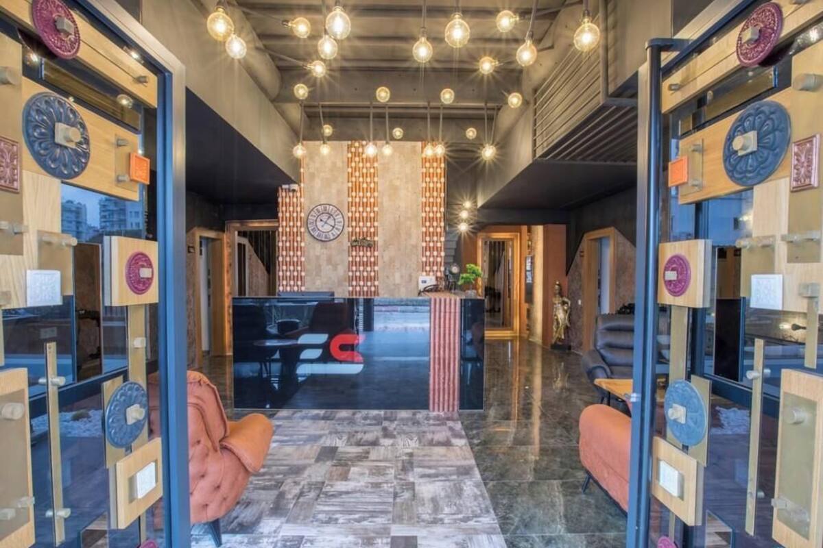 A lobby with a reception desk, seating area, and decorative wall panels.