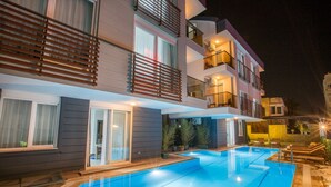 A modern multi-story building with a swimming pool.