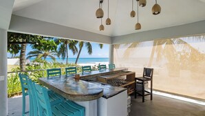 A modern kitchen with a large island, bar area, and seating.