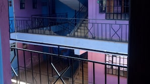 A multi-story building with balconies and staircases. - Esidai Hotel (Mai Mahiu)
