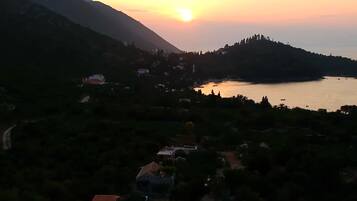 Paisaje montañoso con un cuerpo de agua y edificios dispersos.