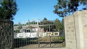 A metal gate with the words "FIREBIRD" in large letters. - Firebird Inn (Naivasha)
