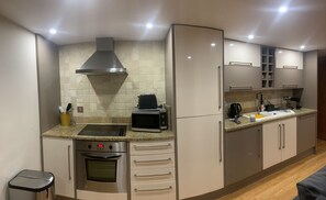 Departamento Deluxe | Cocina privada | Refrigerador, microondas, horno y parrilla de estufa 