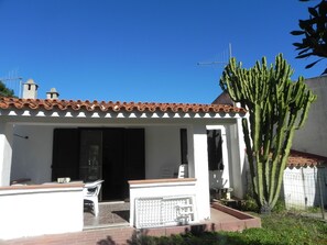 A white building with a tiled roof and a large cactus in the yard. - Fantastic Sardinia Mare AND01 FSG-AND01 (Posada)