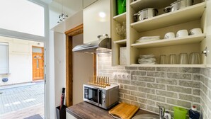 Apartment (Split Level) | Private kitchen | Full-sized fridge, microwave, stovetop, cookware/dishes/utensils